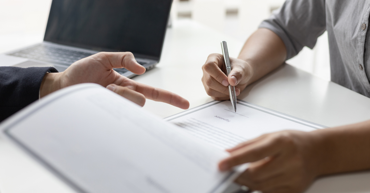 woman signing an agreement