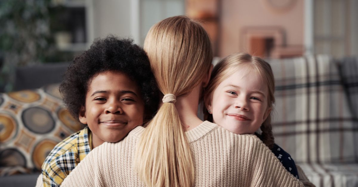 mum hugs her interracial children