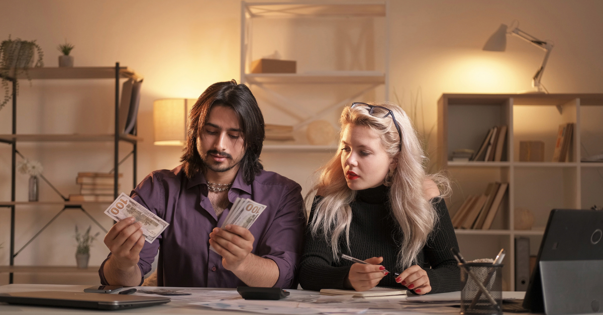 couple counting money and planning budget for surrogacy